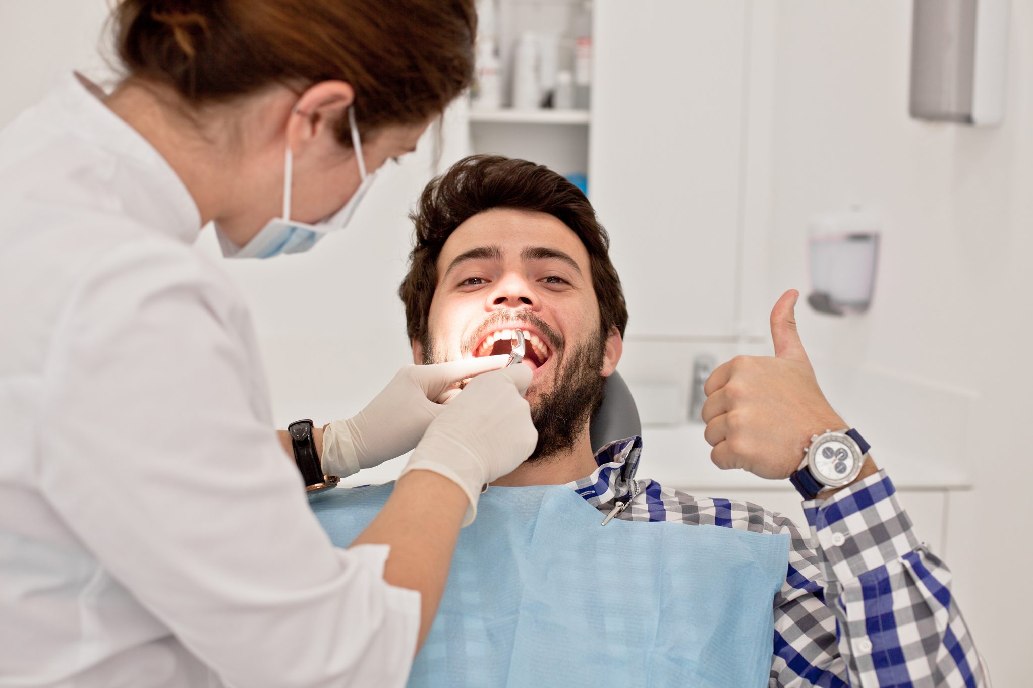 young man and woman in a dental examination at dentist